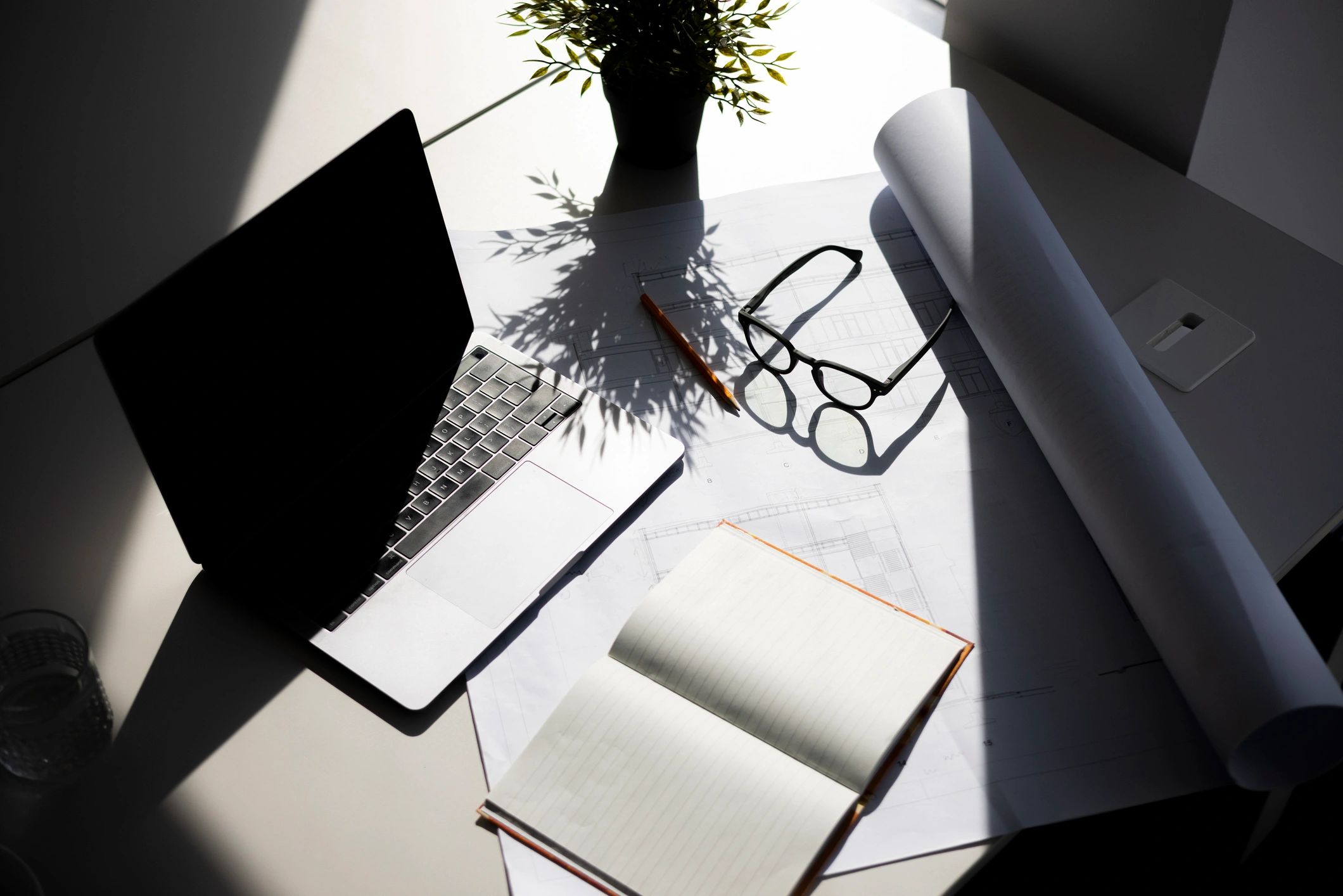 Minimal workspace with laptop, notebook, and documents