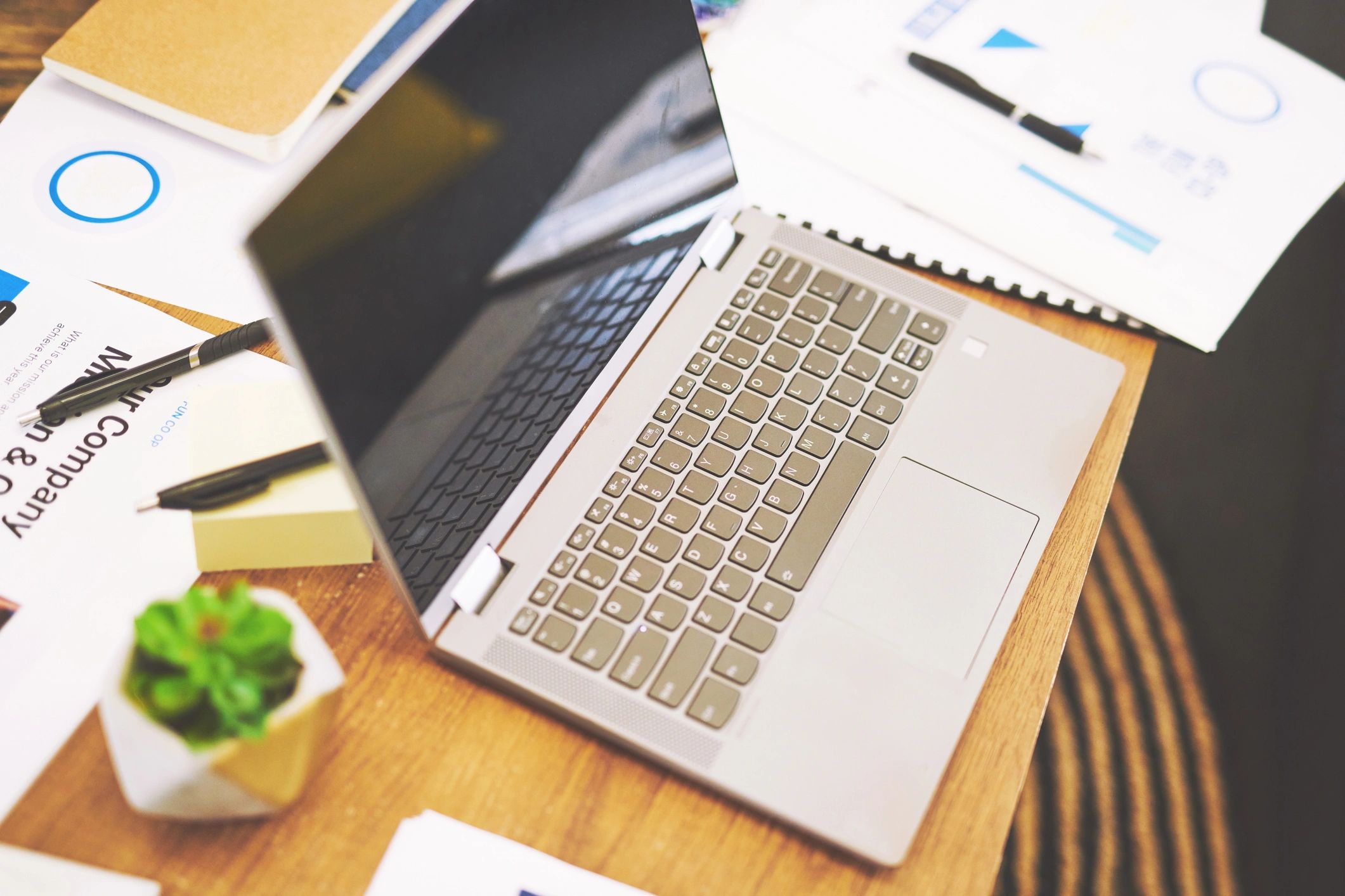 Laptop and paperwork on a clean office desk