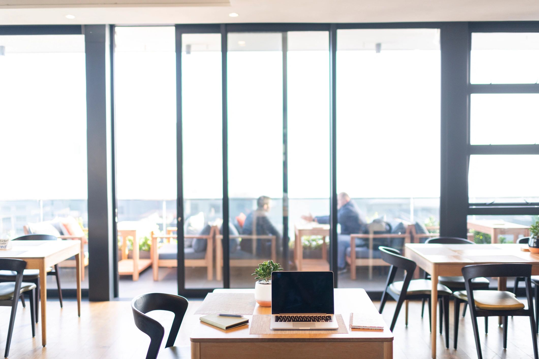 Minimal editorial workspace with laptop and notebook