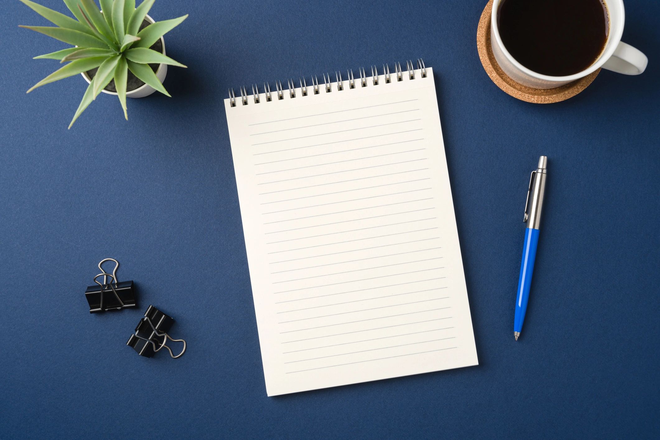 Minimal desk with notebook and pen for presentation editing