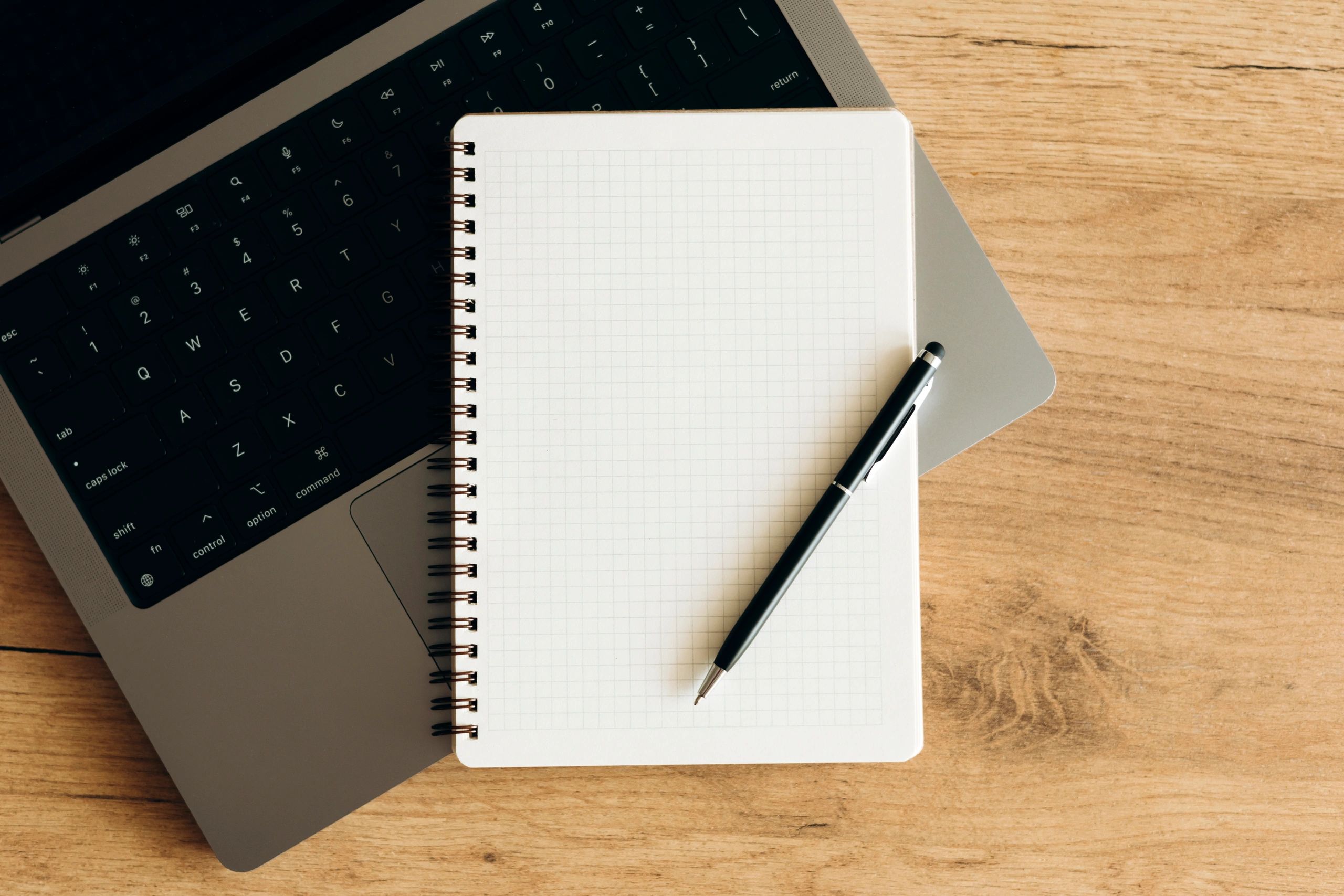 Minimal workspace with laptop and notebook